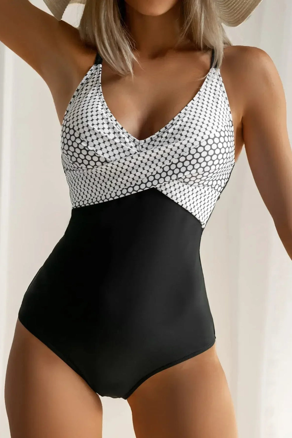 Black and white patterned swimsuit worn by a model against a neutral background