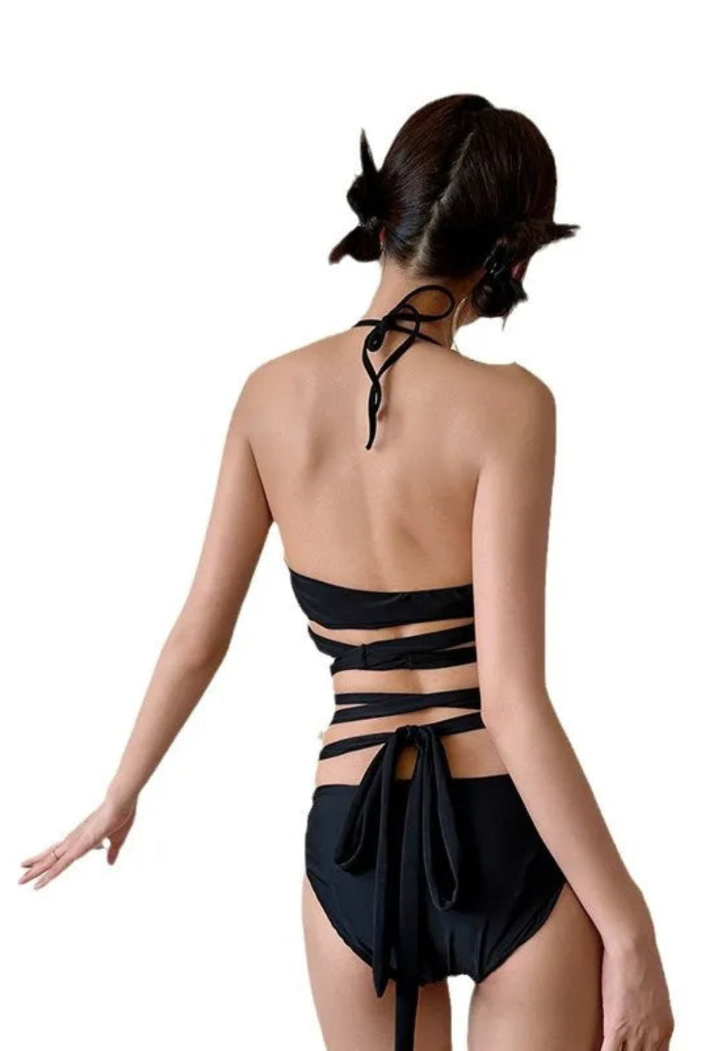 Woman wearing a black bikini with a white background