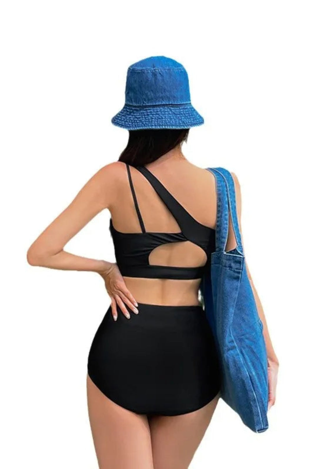 Woman wearing a black swimsuit and blue denim hat with a blue denim bag on a white background