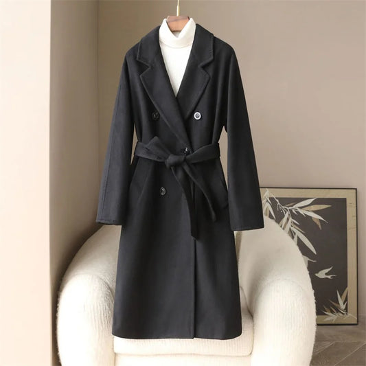 Black coat with a white shirt underneath on a beige chair.