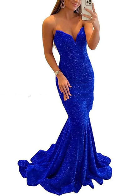 Woman wearing a blue sparkly evening gown on a white background