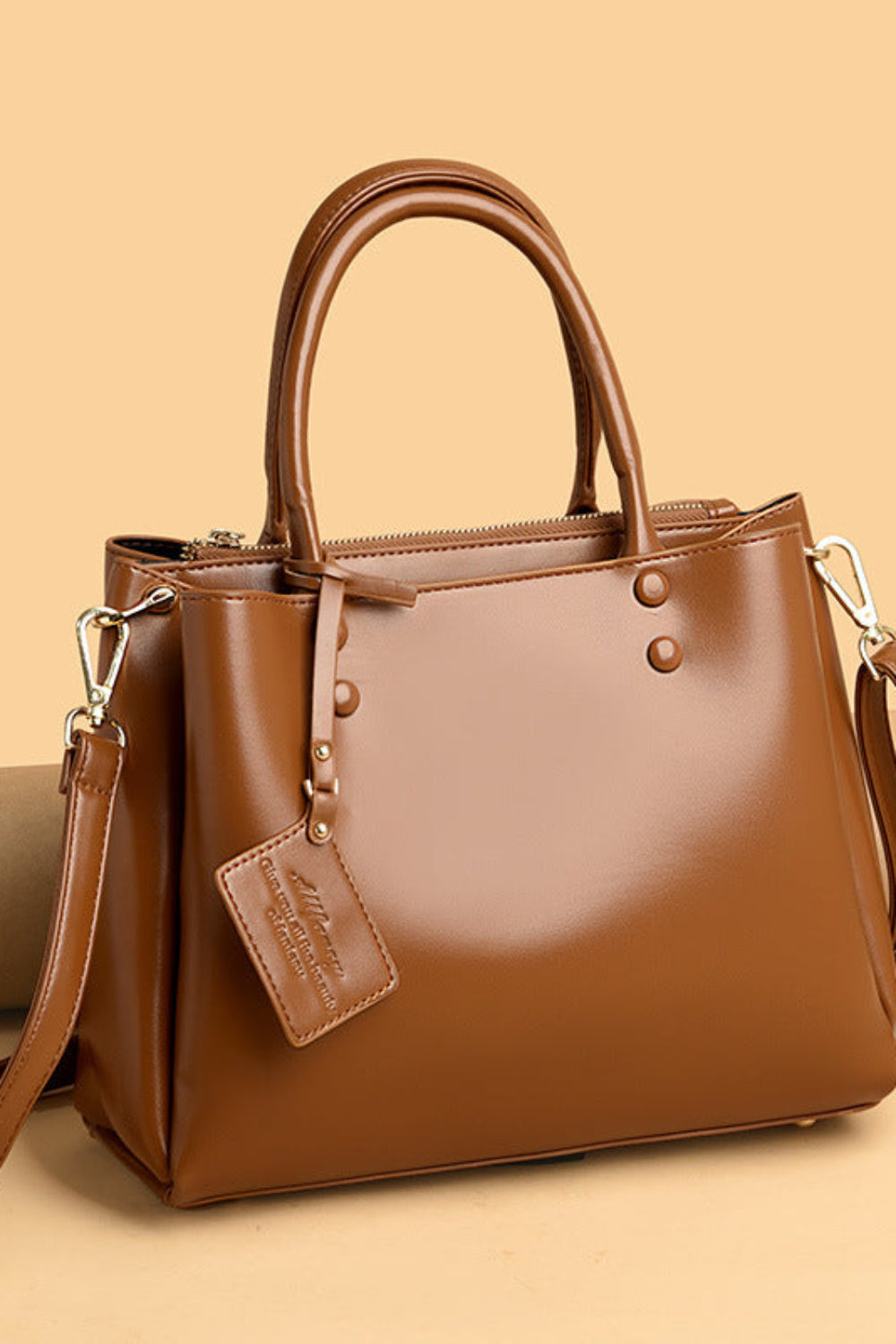 Brown handbag with a strap on a beige background