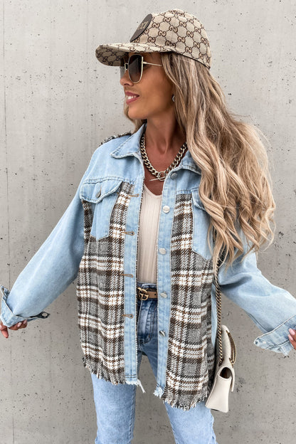 Woman wearing a denim jacket, plaid scarf, and Gucci cap against a concrete wall.