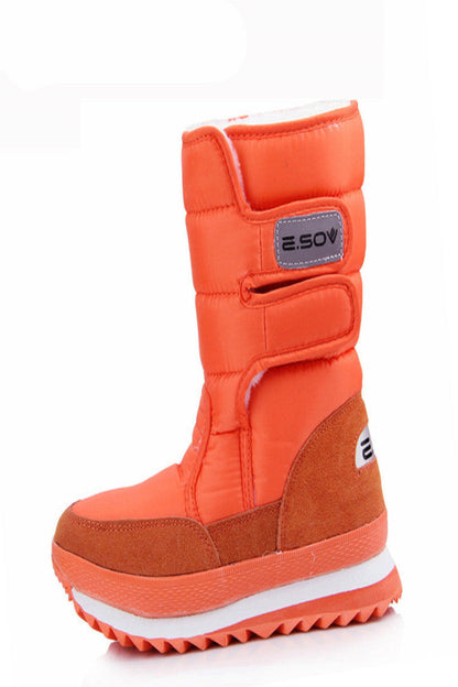 Orange winter boot with a visible brand label on a white background