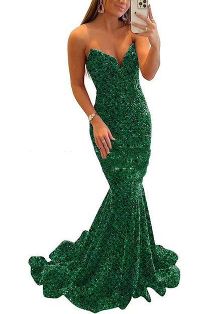 Green sequin dress worn by a person on a white background