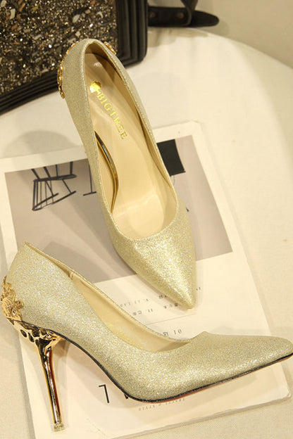 Gold high-heeled shoes with decorative heel on a magazine