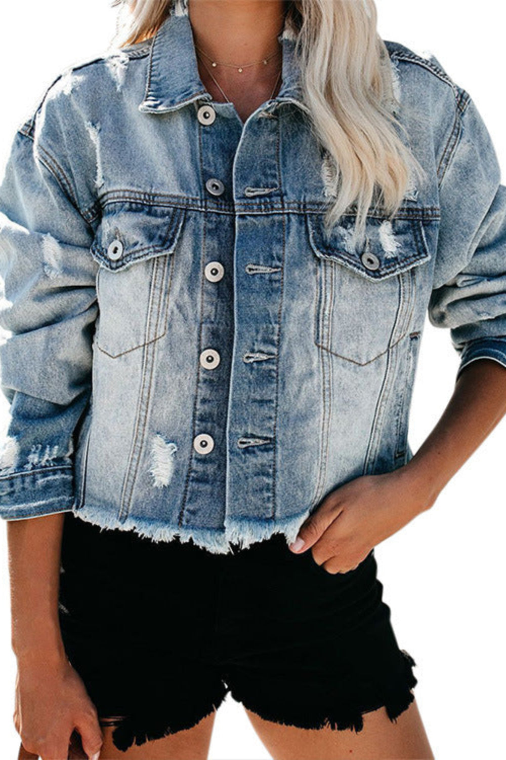 Denim jacket worn by a person on a white background