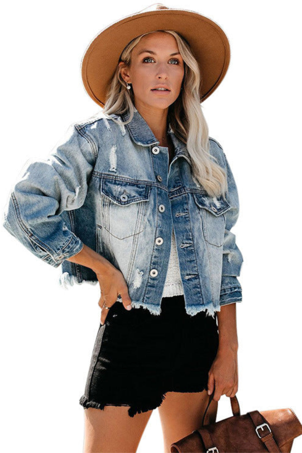 Woman wearing a denim jacket, black shorts, and a brown hat on a white background
