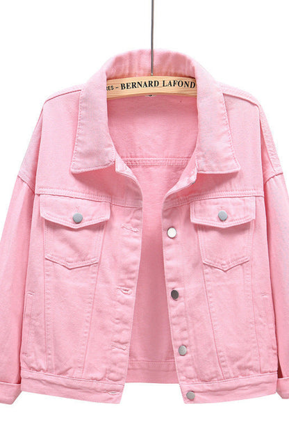 Pink denim jacket on a hanger with a white background