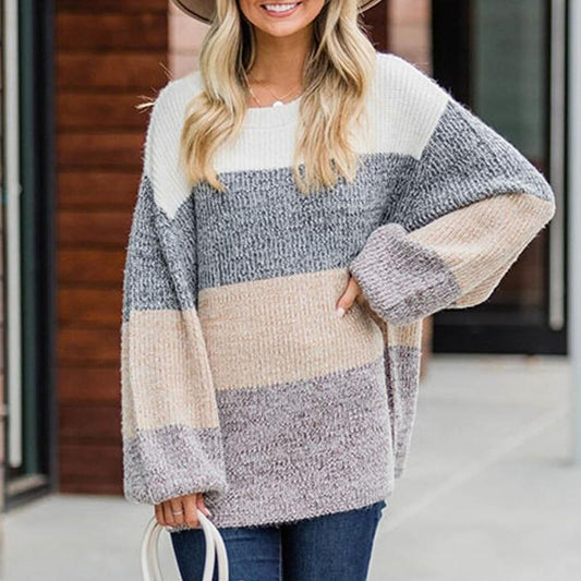Woman wearing a color-blocked sweater with a blurred background