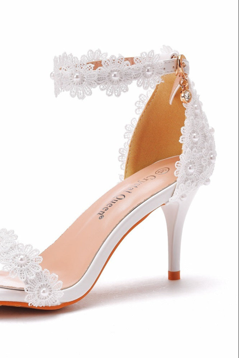 White high-heeled sandal with lace details on a white background
