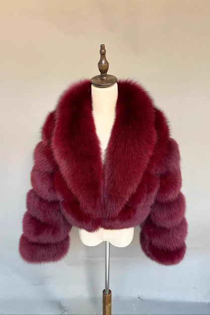 Red fur coat on a mannequin against a plain background
