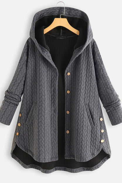 Gray quilted coat with buttons on a hanger against a white background
