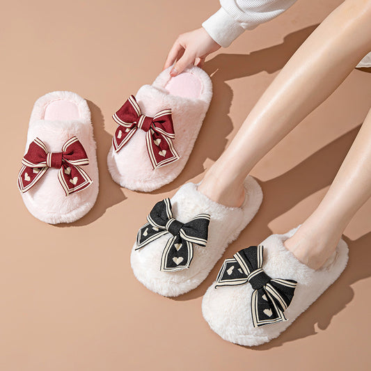 White slippers with decorative bows on a beige background