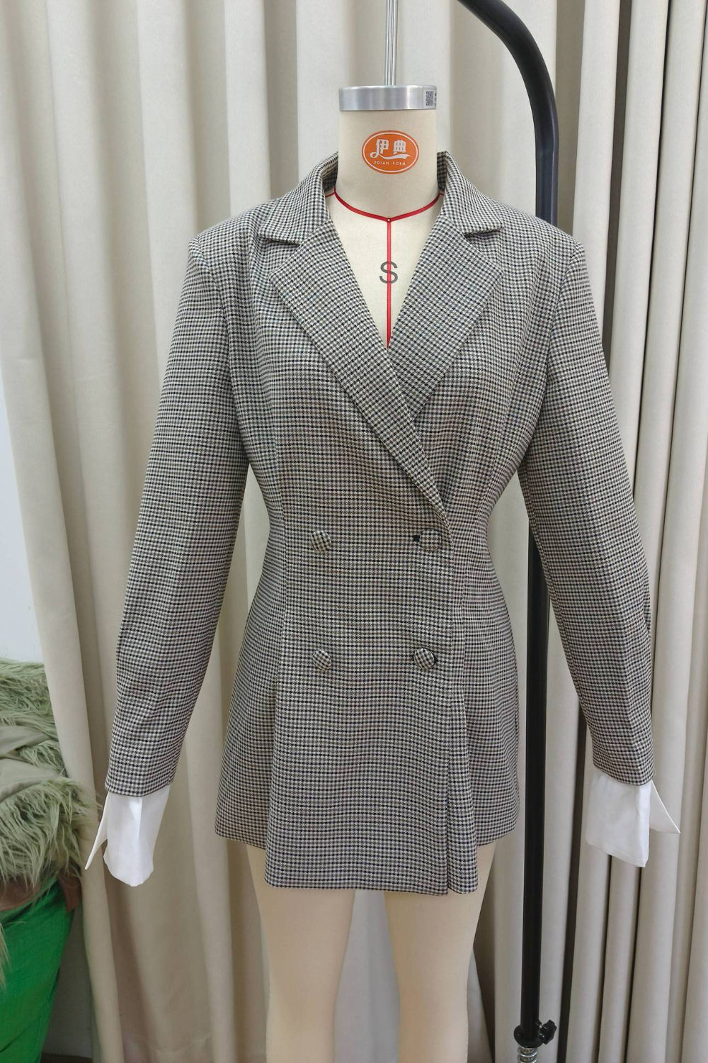 Gray checkered blazer on a mannequin against a neutral background