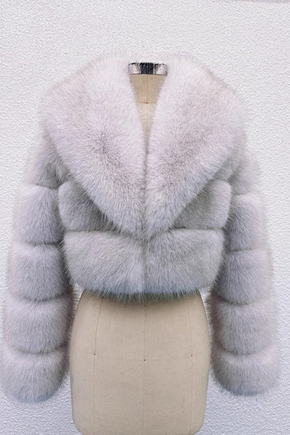 Light blue fur coat on a mannequin against a white background