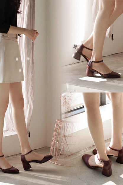 Two people wearing brown shoes standing on a platform with a minimalistic background.