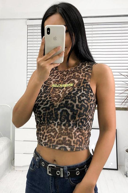 Person wearing a leopard print top with 'NACHMIRE' text, taking a mirror selfie.