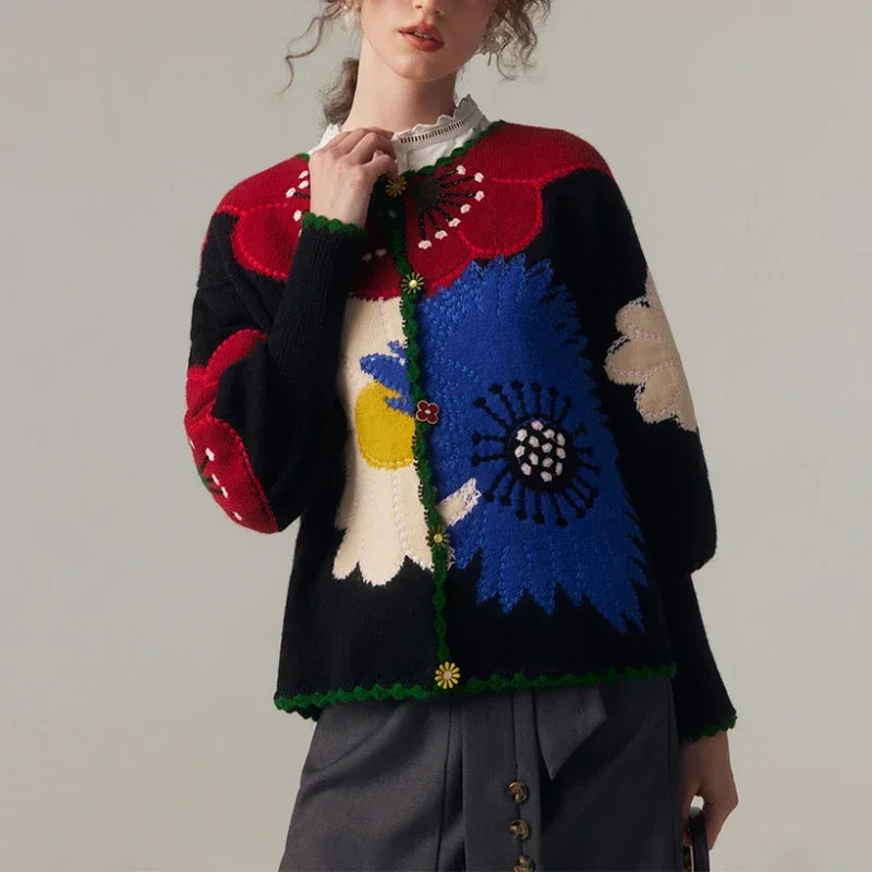 Person wearing a colorful floral-patterned sweater against a plain background