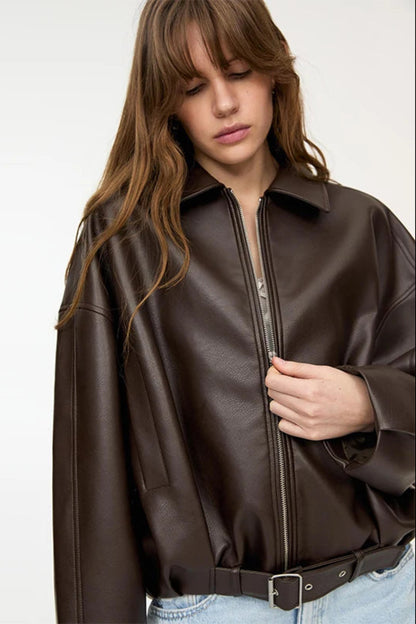 Woman wearing a brown leather jacket on a white background