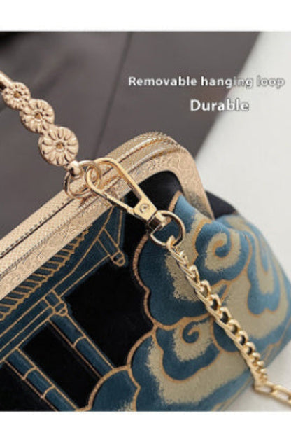 Gold handle with decorative elements on a handbag, featuring text 'Removable hanging loop' and 'Durable'.