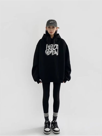 Person wearing a black hoodie with a logo and black pants on a white background