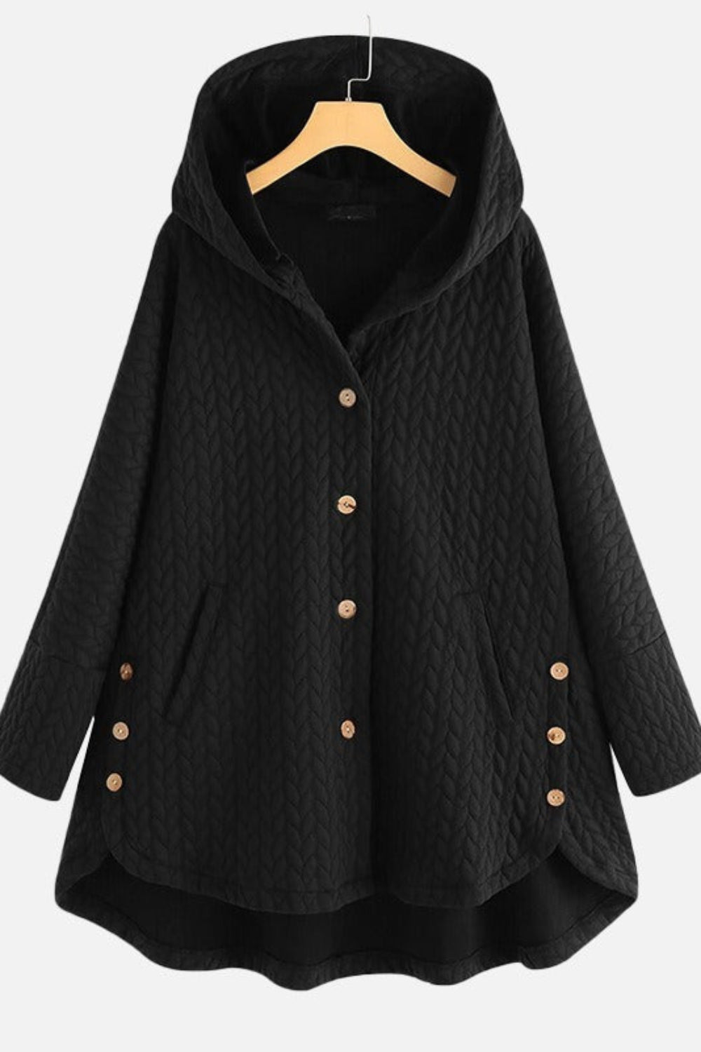 Black quilted coat with gold buttons on a hanger against a white background