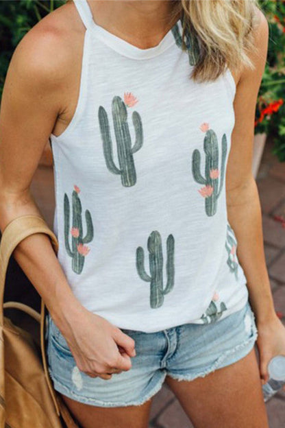 Person wearing a white tank top with cactus print and denim shorts, standing outdoors.