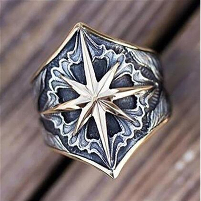 Decorative ring with star design on a wooden surface