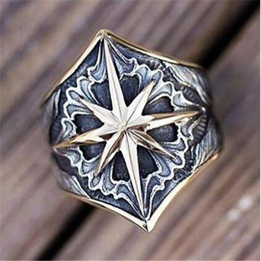 Decorative ring with star design on a wooden surface