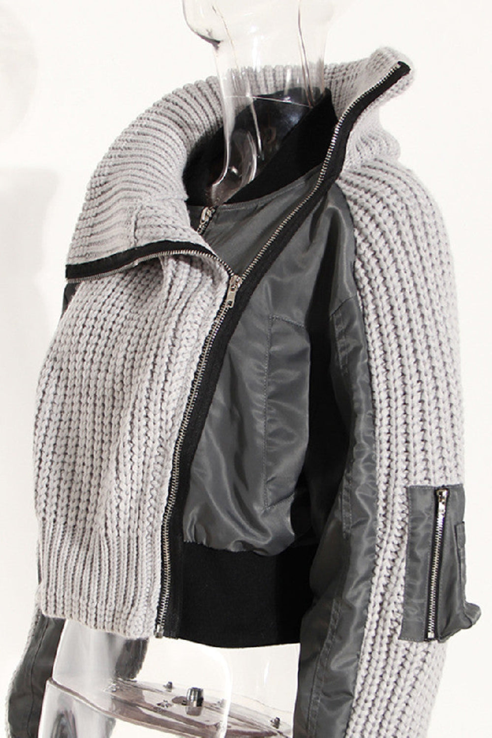 Gray knitted jacket with zipper on a mannequin against a white background