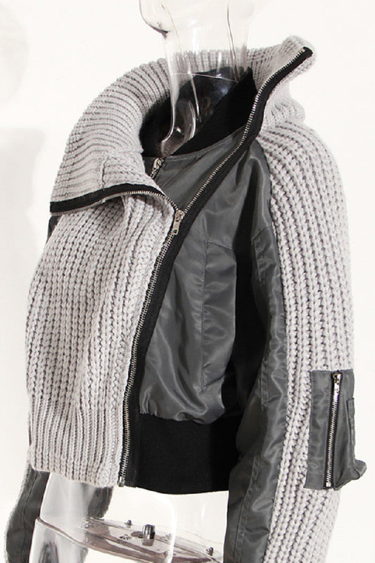Gray knitted jacket with zipper on a mannequin against a white background
