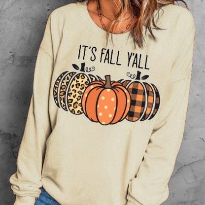Beige sweatshirt with 'It's Fall Y'all' text and pumpkins design on a gray background
