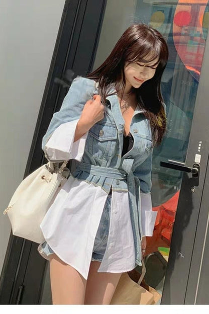 Woman in a denim outfit standing in front of a colorful door.