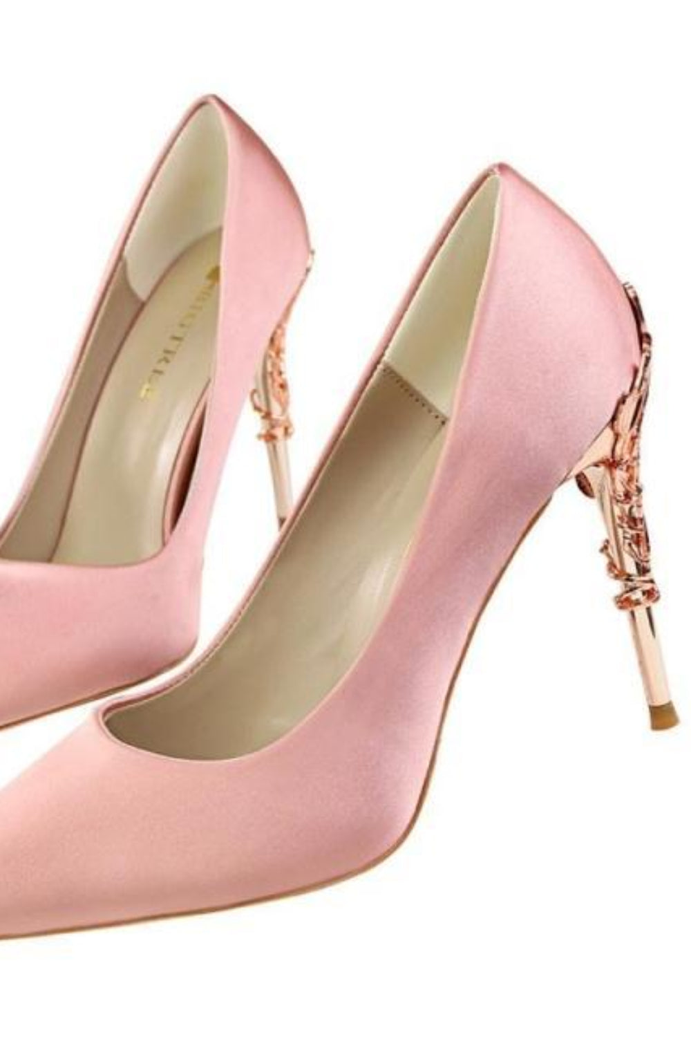 Pair of pink high-heeled shoes with decorative straps on a white background