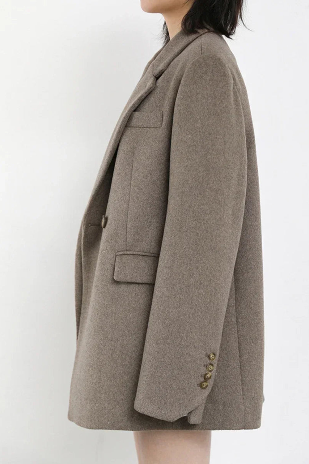 Brown coat worn by a person on a white background
