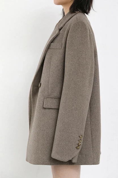 Brown coat worn by a person on a white background