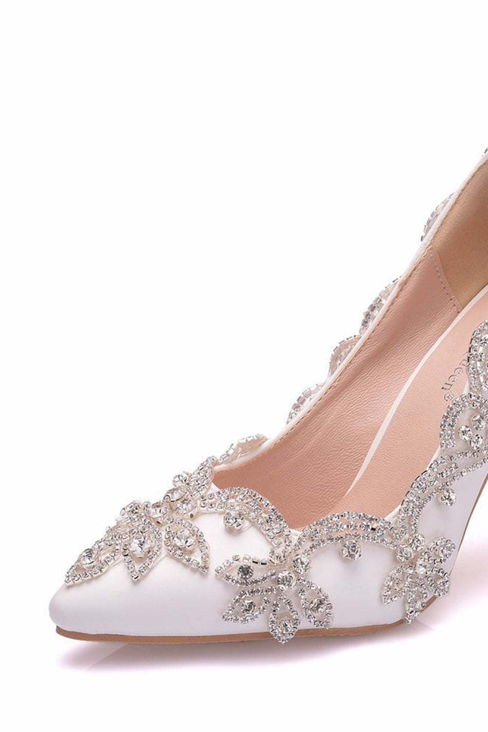 White high-heeled shoe with silver embellishments on a white background