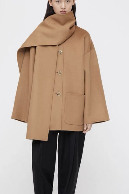 Person wearing a beige coat on a white background