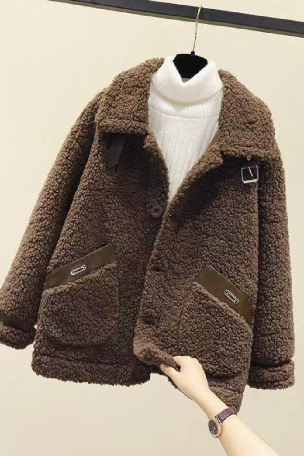 Brown sherpa jacket on a mannequin against a plain background