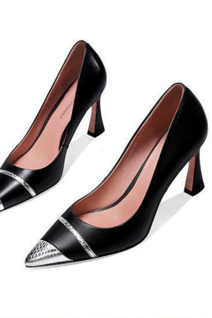 Black high-heeled shoes with silver accents on a white background