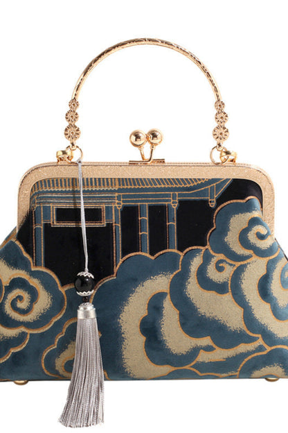 Decorative handbag with gold handle and cloud pattern on a white background