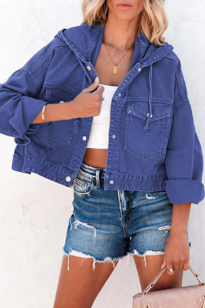 Person wearing a blue denim jacket and shorts on a white background