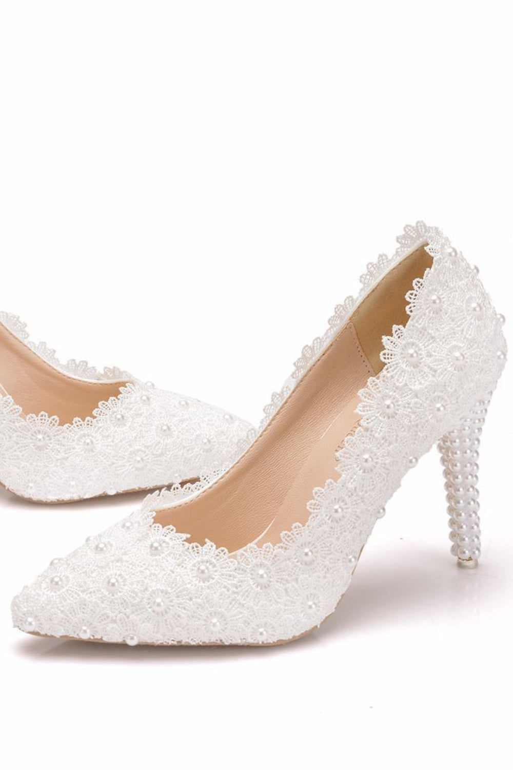 White high-heeled shoes with lace detailing on a white background