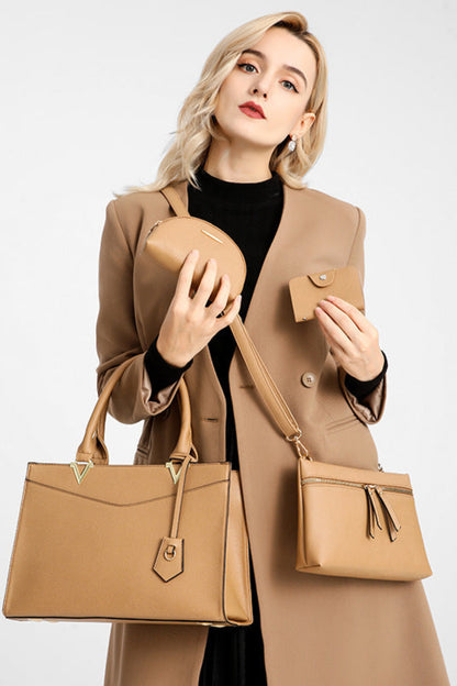 Woman holding a set of beige handbags against a white background