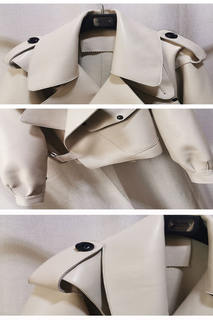 Close-up of a beige trench coat with black buttons on a white background