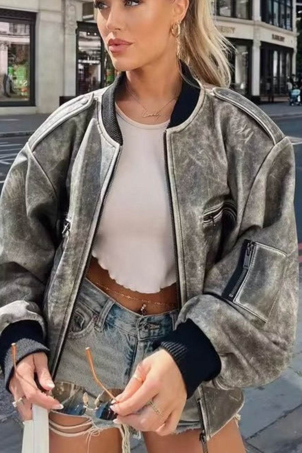 Woman wearing a gray jacket on a city street