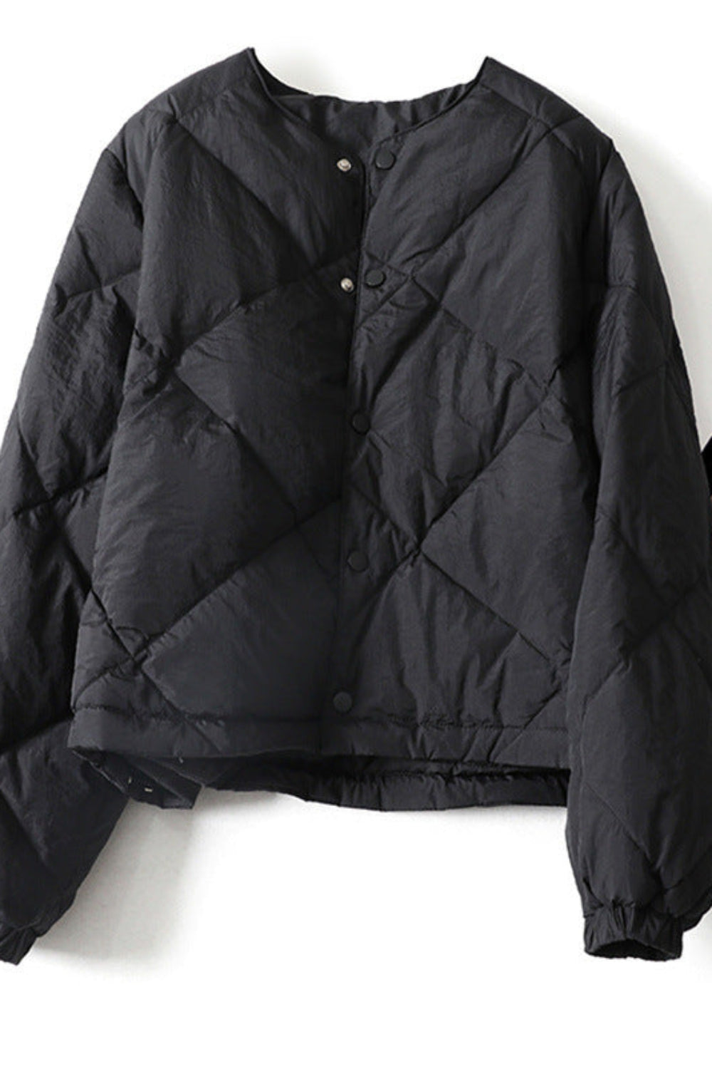 Black quilted jacket on a white background
