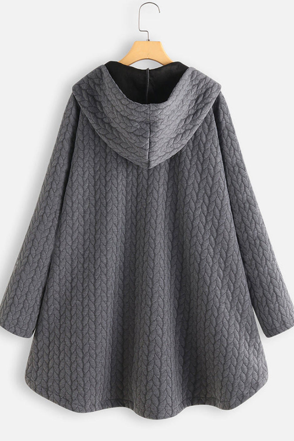 Gray quilted coat on a hanger against a white background