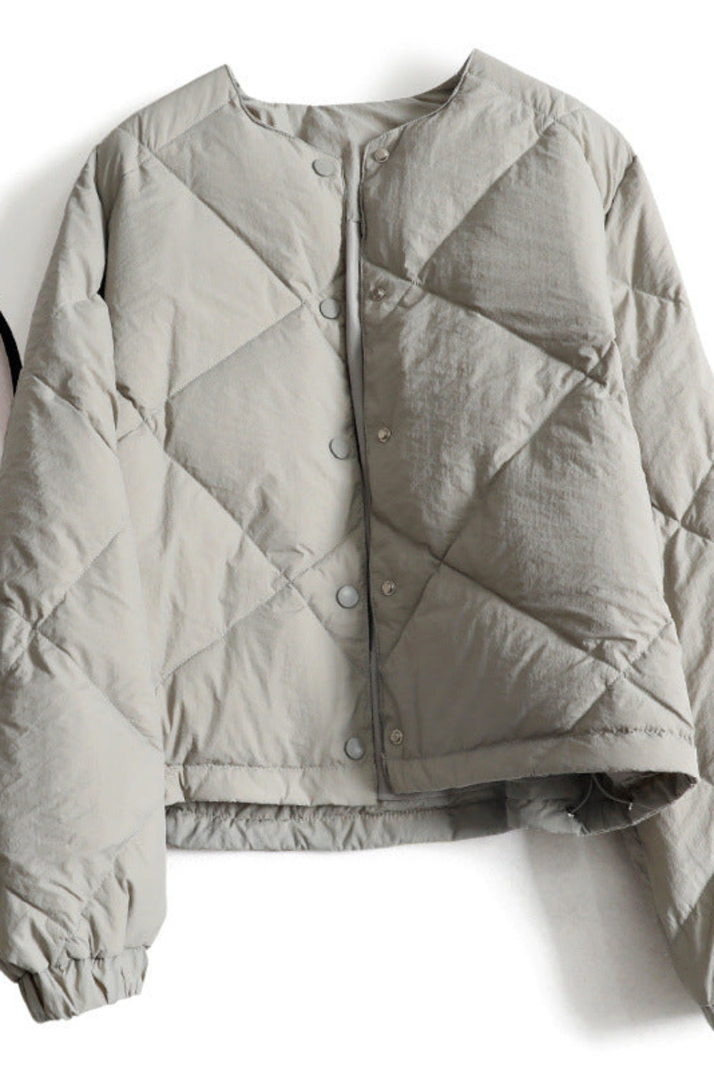 Gray quilted jacket on a white background